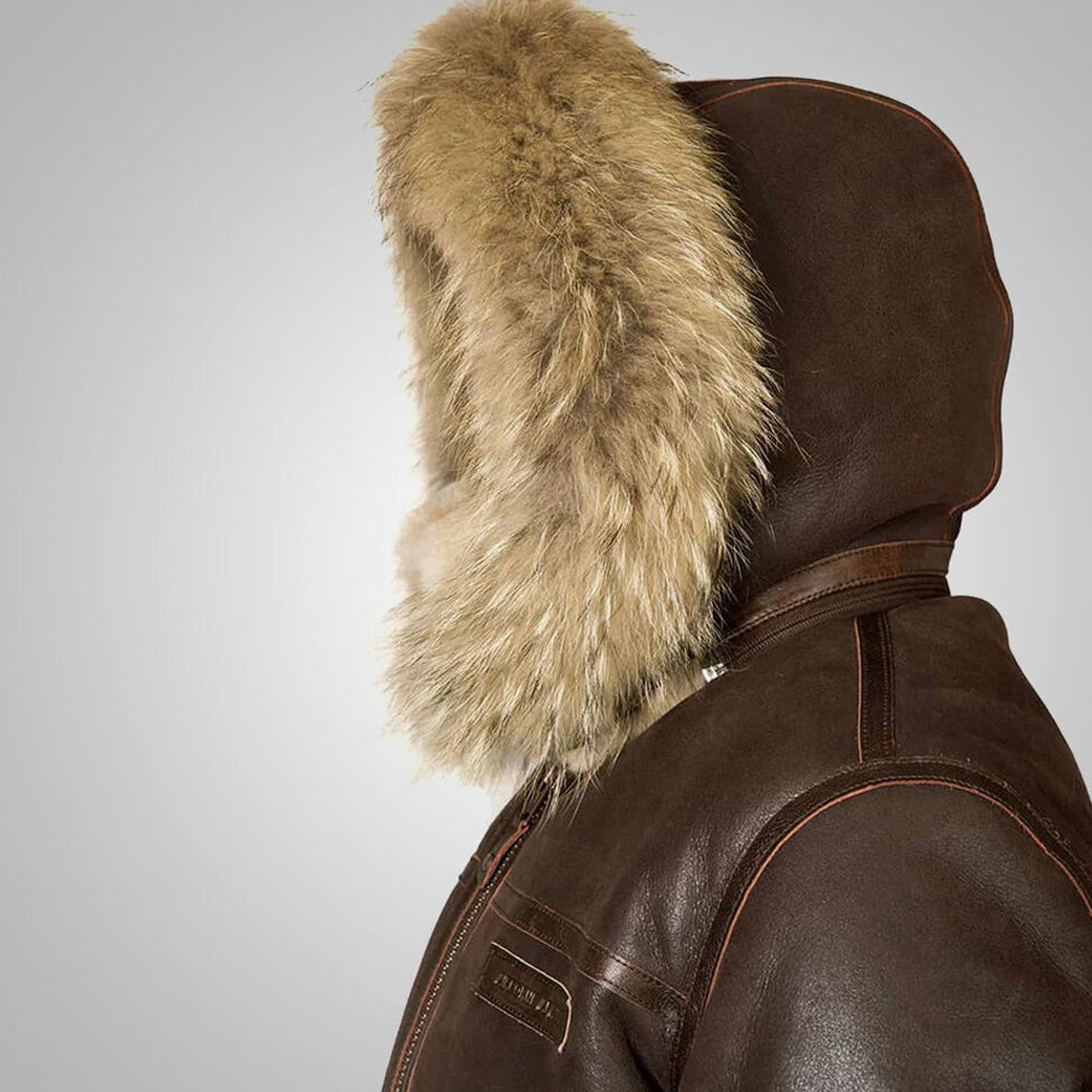 Side profile view of men's fur hooded shearling coat showing generous fur ruff around hood