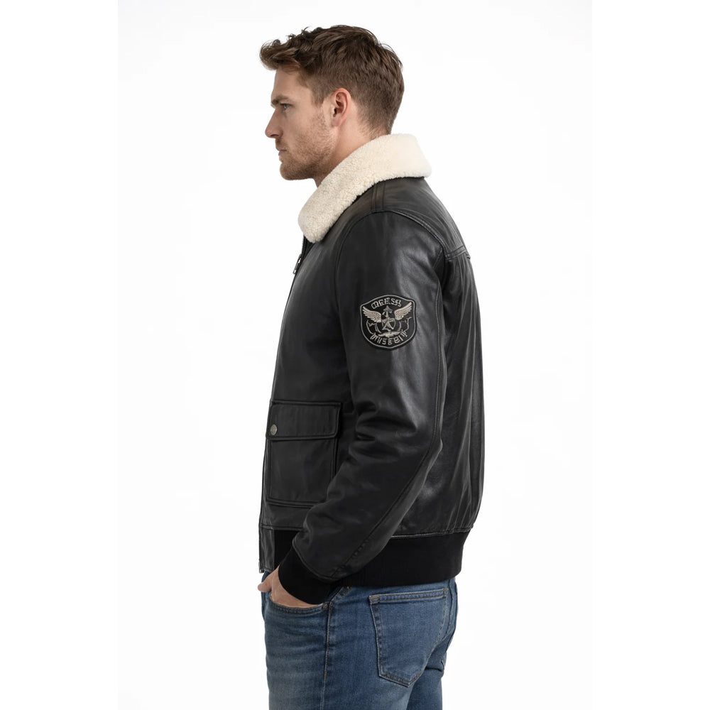 Side profile of men's G-1 aviator leather jacket highlighting embroidered military sleeve patch and ribbed cuffs