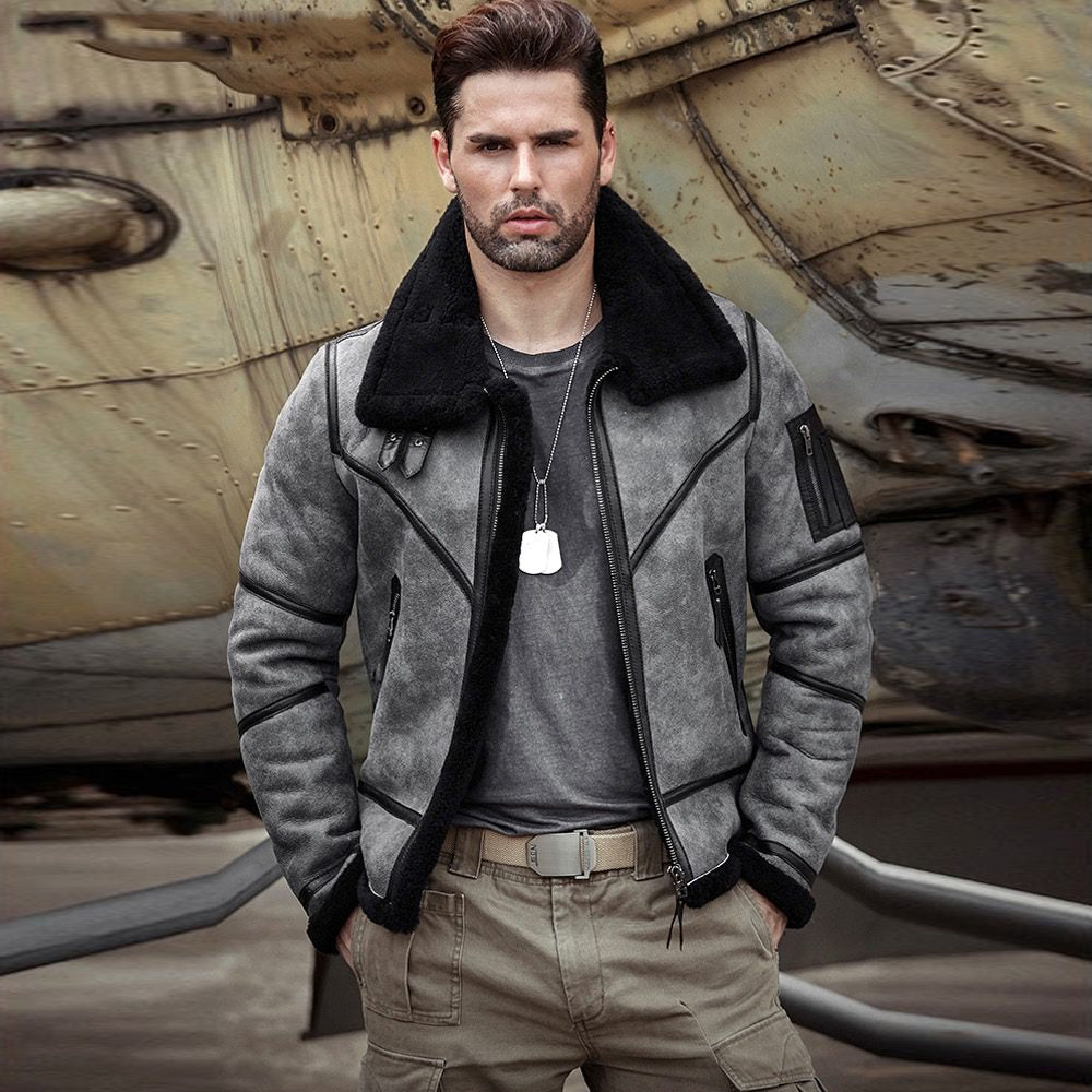Front view of man wearing a grey distressed B3 shearling aviator jacket with black collar and zip pockets