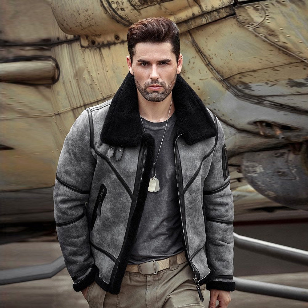 Men’s grey shearling flight jacket with black leather seam trim, angled zip pockets and exposed shearling cuffs