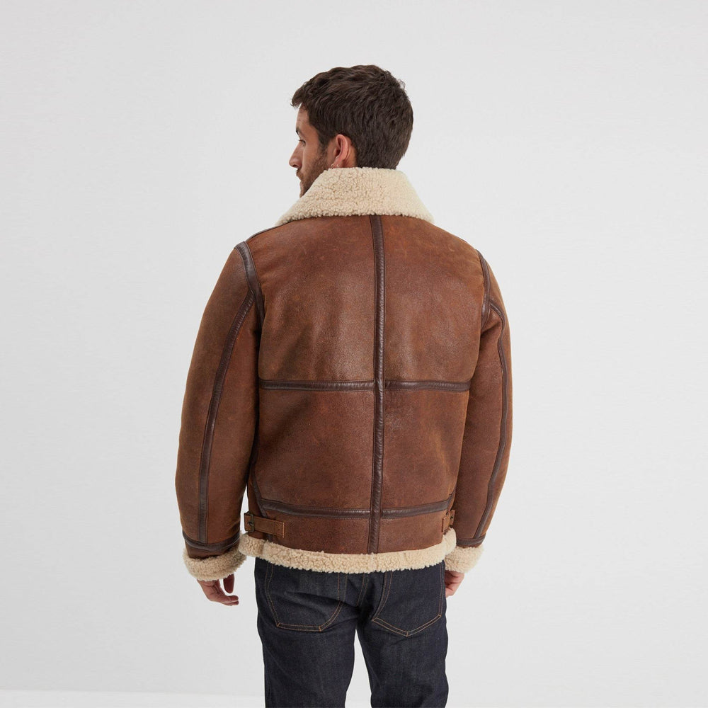Back view of men’s brown B-3 jacket showing dark vertical and horizontal grid-seam bindings with cream shearling collar and hem