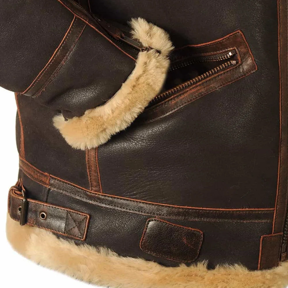 Detail shot of zippered slant hand pocket and adjustable side waist strap with brass roller buckle