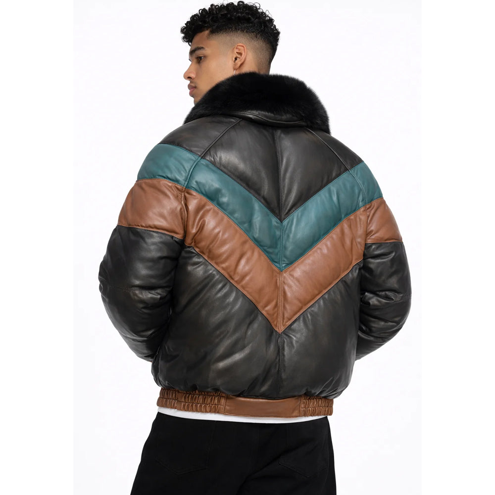 Man wearing black teal and tan leather V-bomber down jacket with detachable fox fur collar