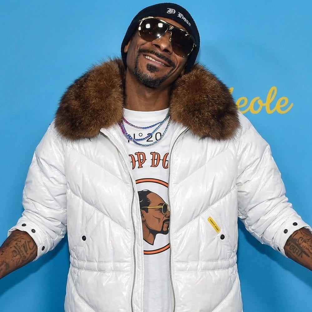 Man wearing off-white leather down coat with fur collar and sunglasses, street style portrait