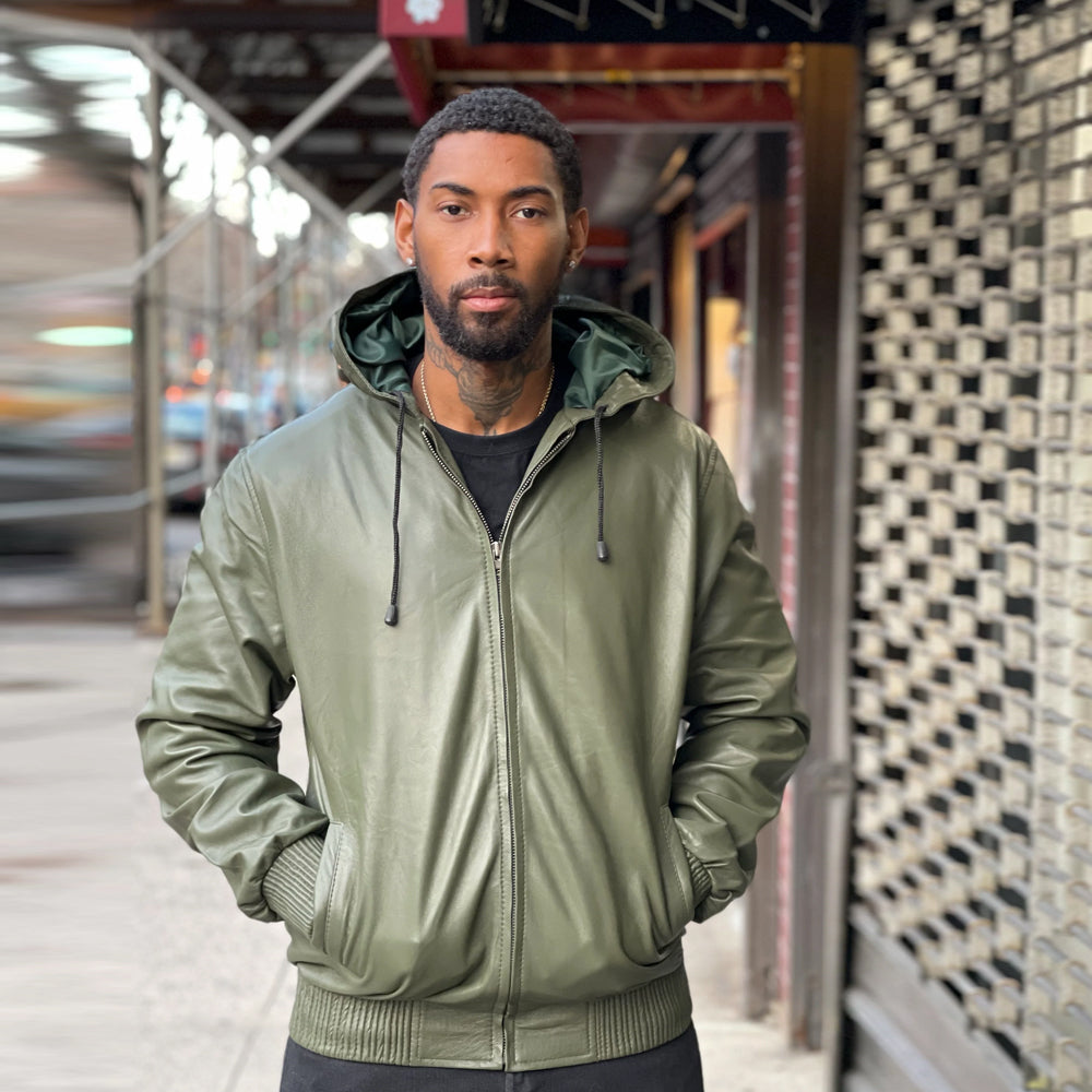 Men’s olive full-zip leather hoodie shown with hood down, green satin interior, silver YKK zipper and matching knitted waistband.