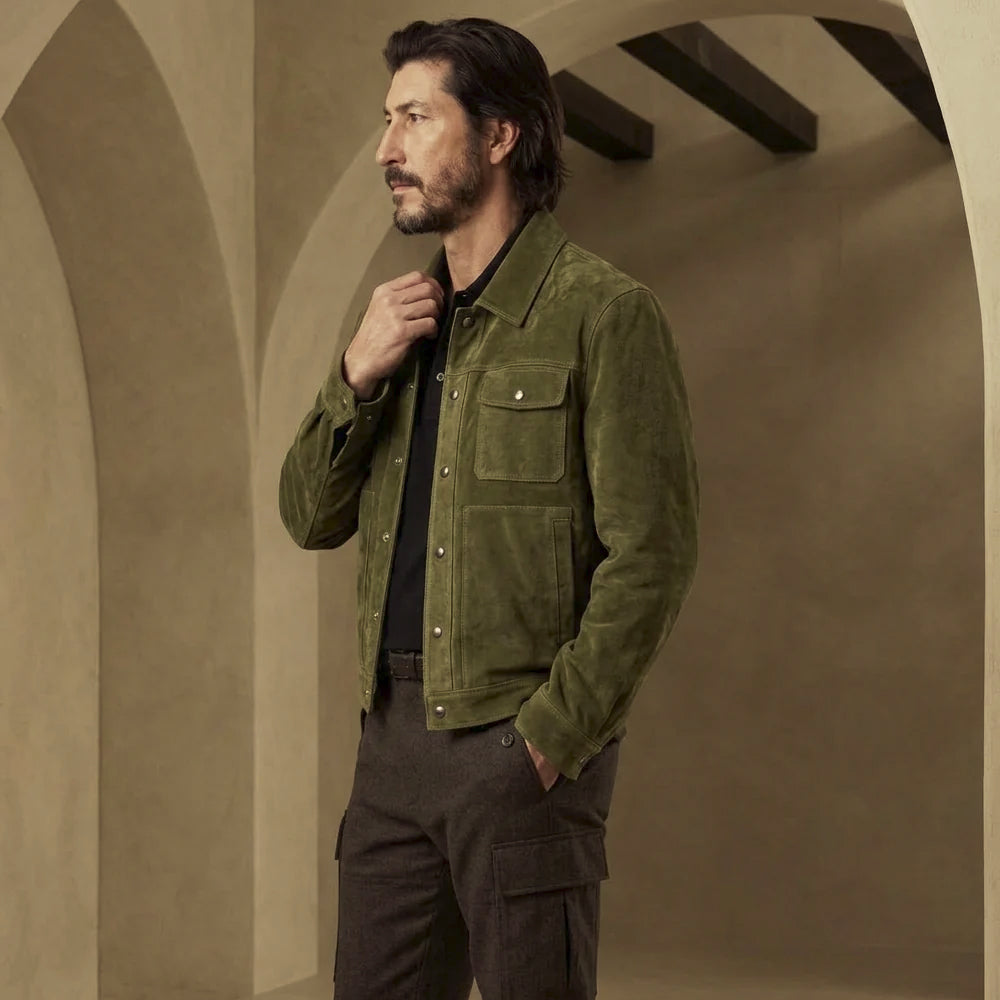 Three-quarter view of men’s olive goat suede snap jacket showing pointed collar, chest flap pocket and lower hand entry.