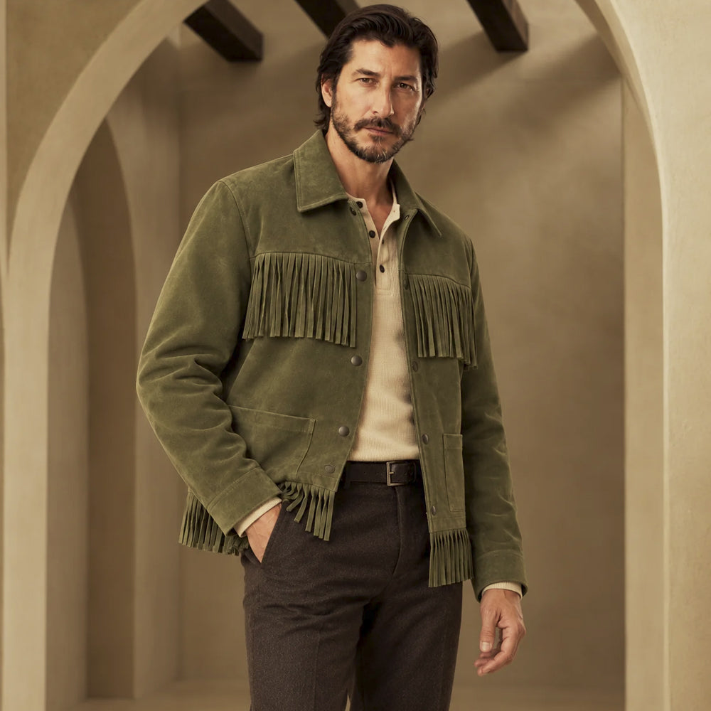 Three-quarter view of men's olive goatskin suede fringe jacket with snap front, chest fringe and lower patch pockets.