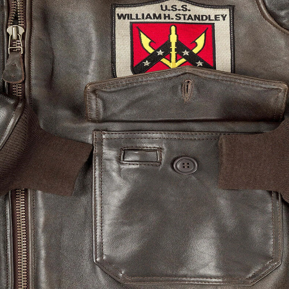 Close-up of front cargo patch pocket with integrated pen slot and button flap on men's G-1 flight jacket.