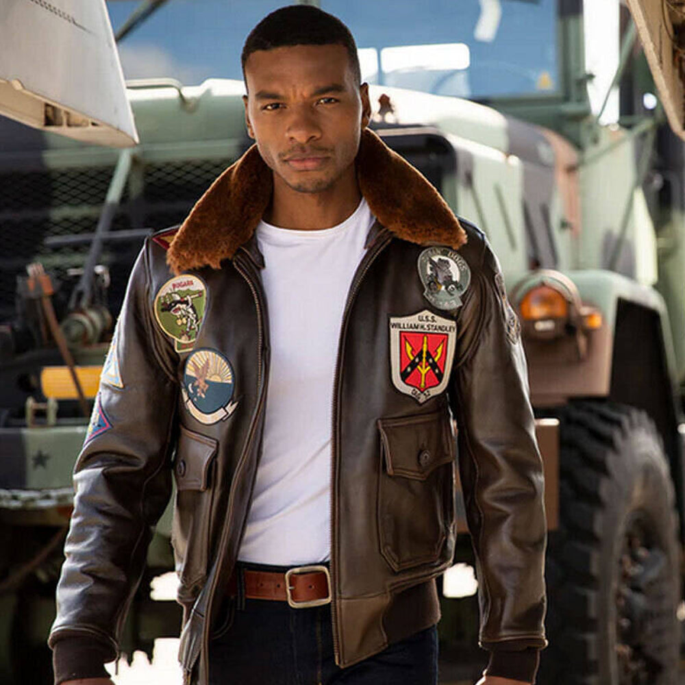 Model posing in men's patched naval aviator leather coat with open shearling collar.