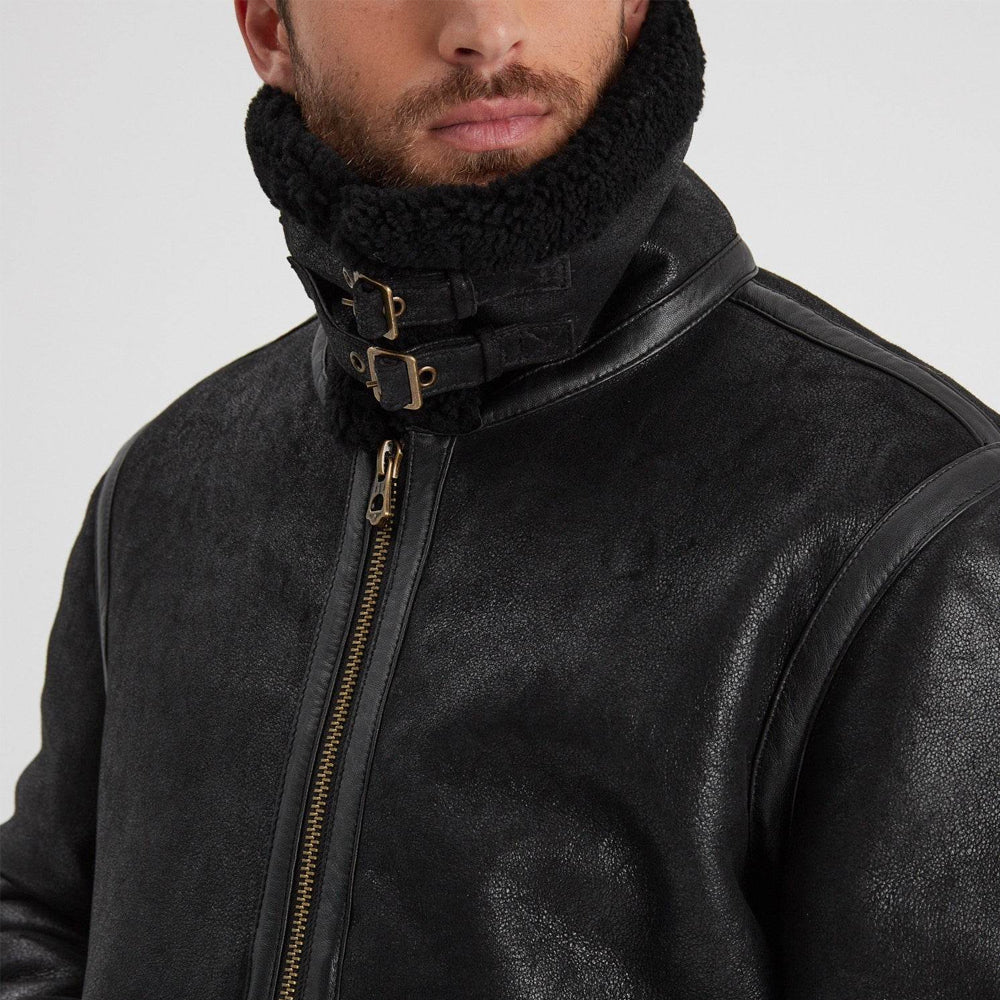 Men’s black RAF shearling jacket with raised storm collar, twin buckle closures, and antique-metal front zip