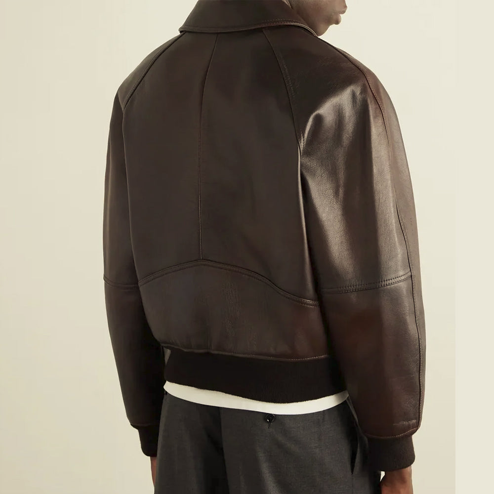 Rear three-quarter view of the men’s raglan leather bomber showing a center seam and sculpted curved back panel