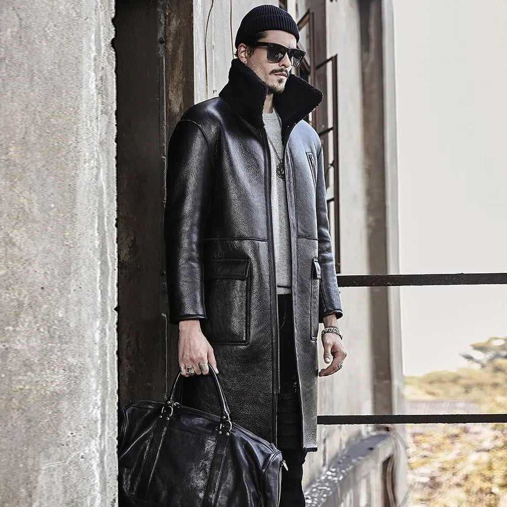 Man standing near window wearing open reversible leather coat with beanie