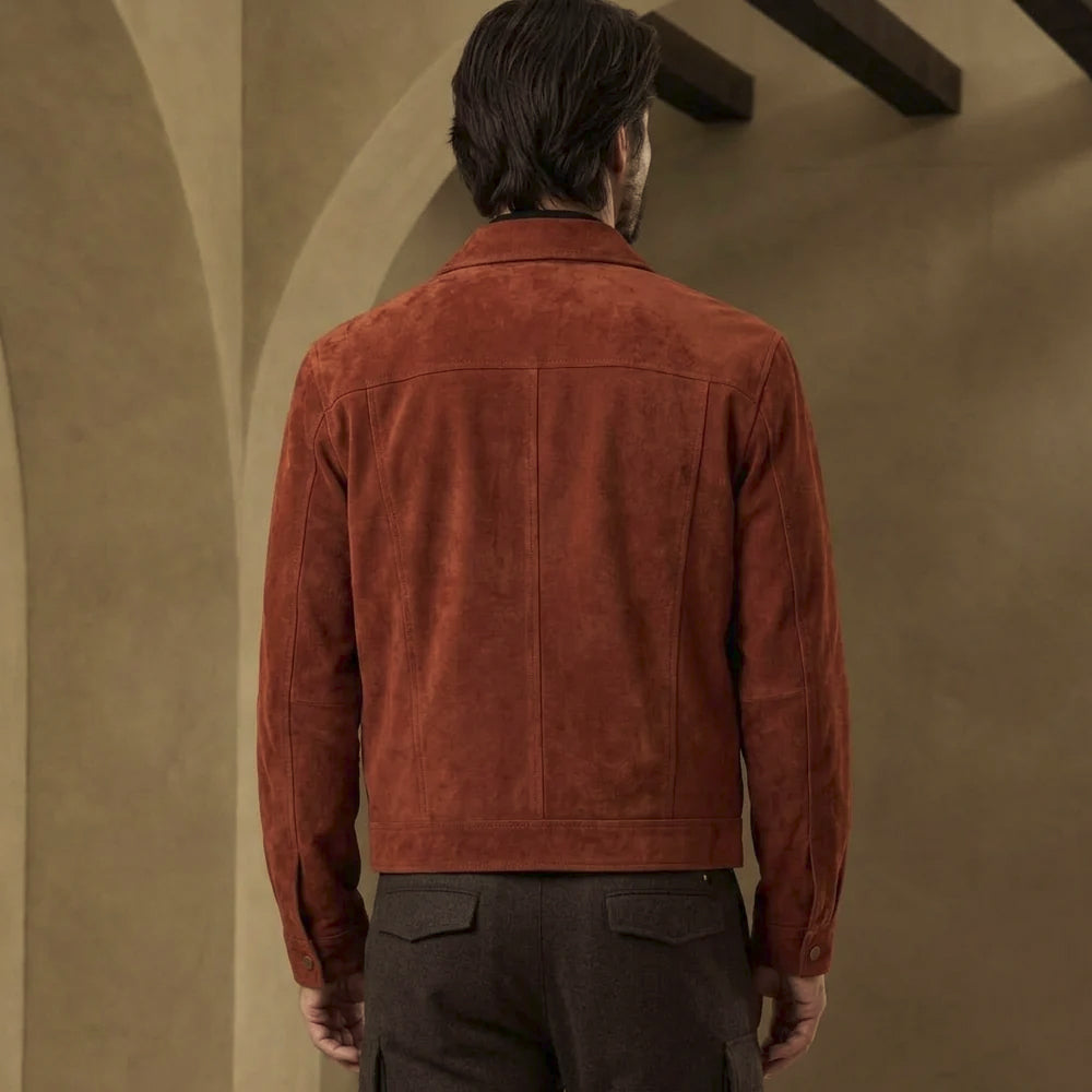 Back view of men’s rust suede trucker jacket showing horizontal shoulder yoke, center seam, shaped side panels and plain straight hem.