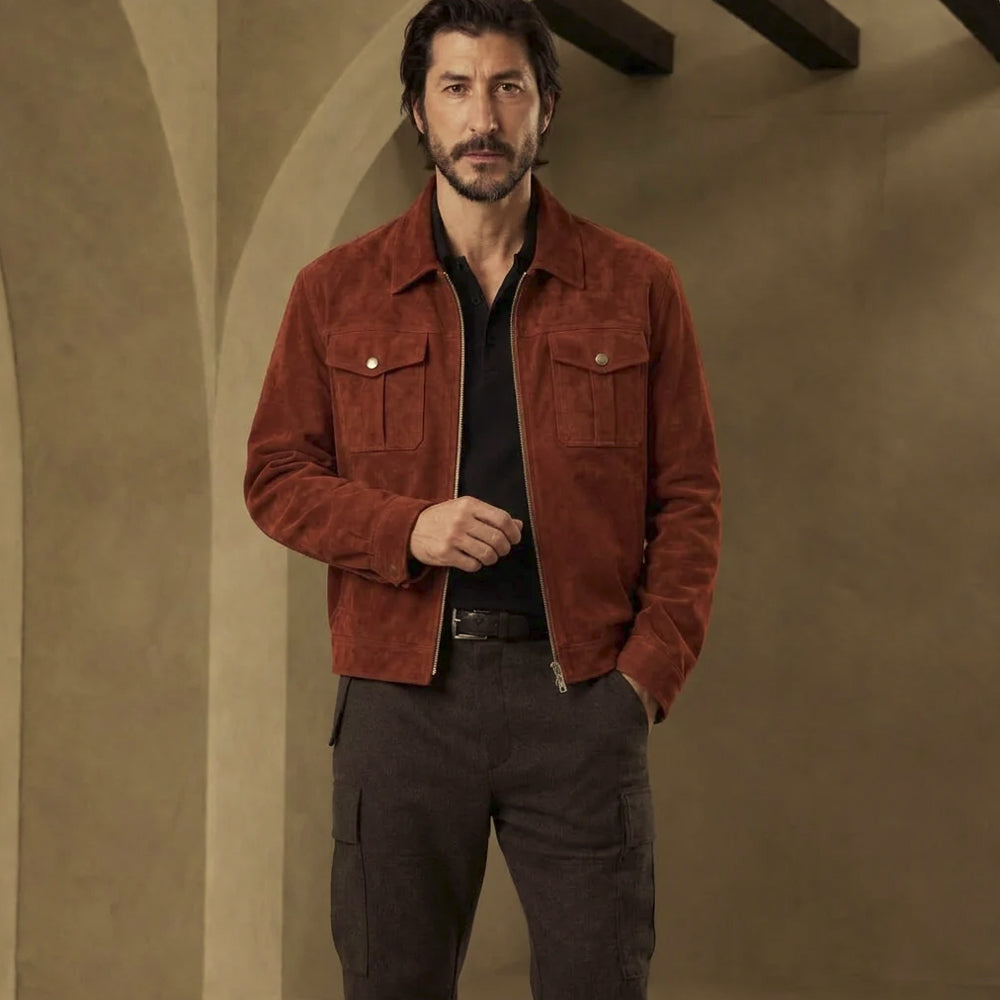 Front view of men’s rust suede trucker jacket with silver zipper, two snap chest pockets and two lower welt hand pockets.