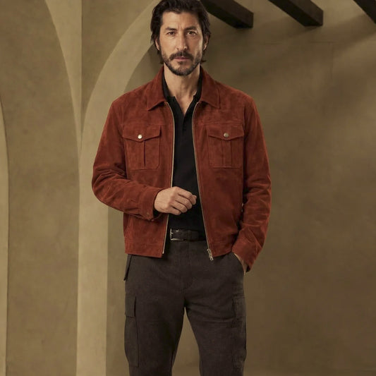 Front view of men’s rust suede trucker jacket with silver zipper, two snap chest pockets and two lower welt hand pockets.