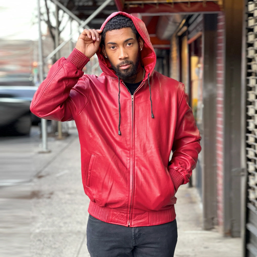 Front view of men’s scarlet full-zip leather hoodie with hood raised, black drawcords, silver YKK zipper and slanted welt pockets.
