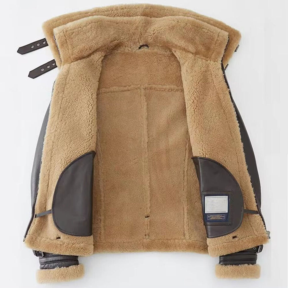 Interior view of men's shearling aviator jacket showing plush honey beige fur lining and leather patch pockets