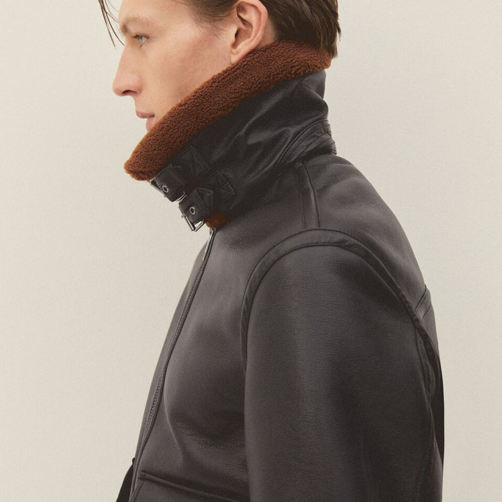 Side profile close up of men's shearling collar flight jacket with upright double buckle collar fastened