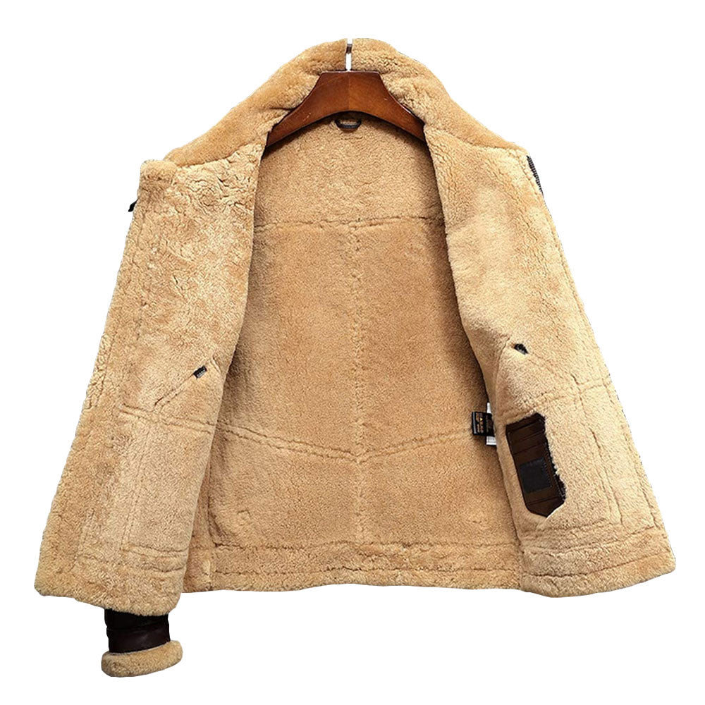 Interior view of men's shearling flight coat showcasing full honey-tan fleece lining and stitched internal leather patch pocket.