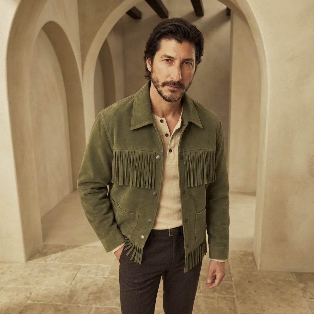 Men's snap-front suede Western jacket styled with a cream henley and dark trousers, showing chest and hem fringe.