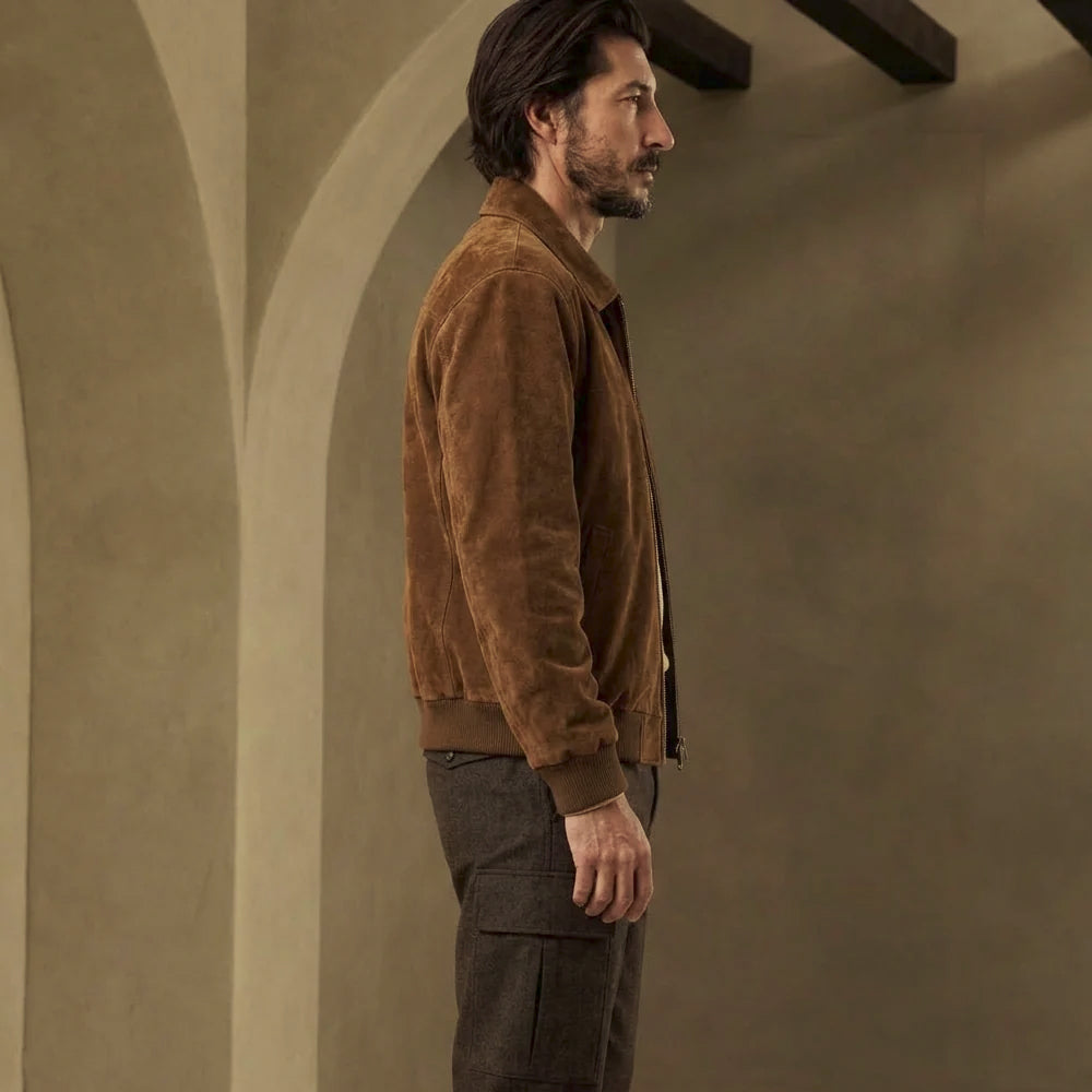 Alternate side angle of men’s suede bomber displaying chestnut nap, fitted rib-knit cuff and clean logo-free flight silhouette.