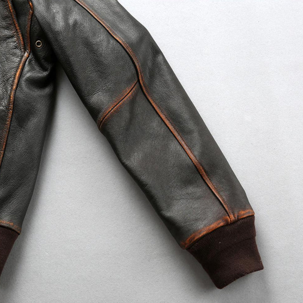 Detailed view of distressed tea-core seams along sleeve arm and stretch ribbed wrist cuff.