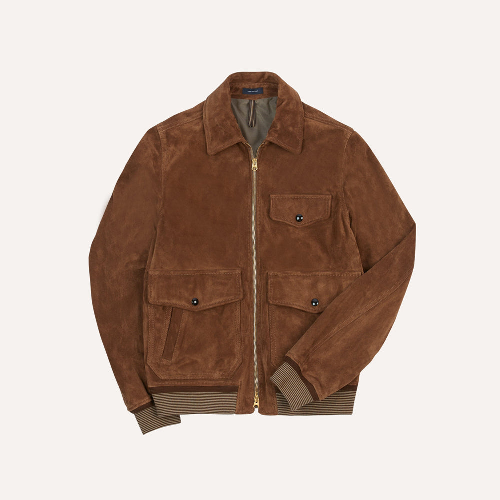 Front flat-lay view of men's tobacco calfskin suede jacket with gold two-way zipper, three flap pockets and striped rib trim.