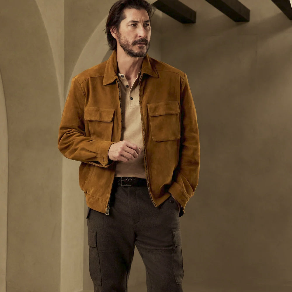 Front view of a men’s tobacco suede utility shirt jacket with point collar, full zipper and four-pocket workwear layout