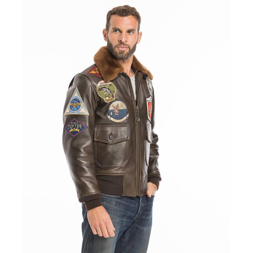 Angled profile view of men's Top Gun cowhide bomber jacket displaying chest insignia patches.