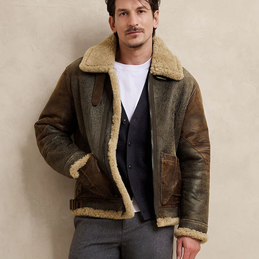 Model wearing men's vintage brown B3 bomber jacket open over white shirt with hands in front cognac pockets