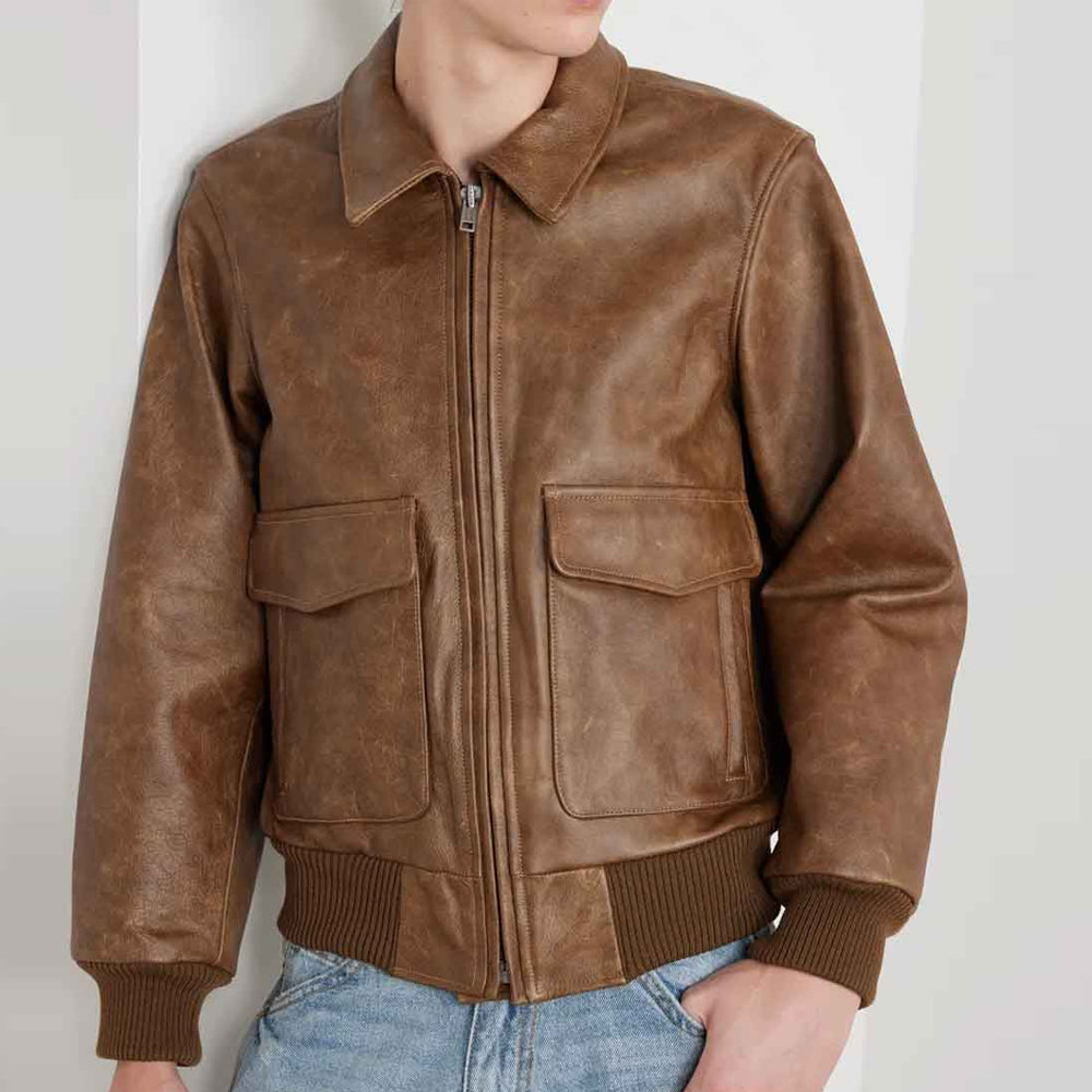Male model wearing the men’s vintage brown graphic flight jacket with rib-knit cuffs, waistband and cargo pockets