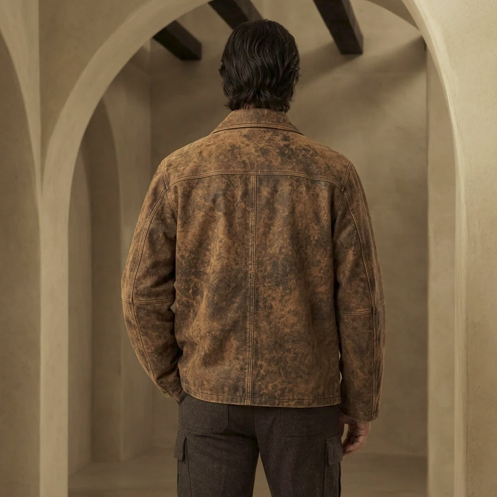 Rear view of men’s vintage chore jacket displaying curved shoulder yoke, center-back seam and clean distressed cowhide panels