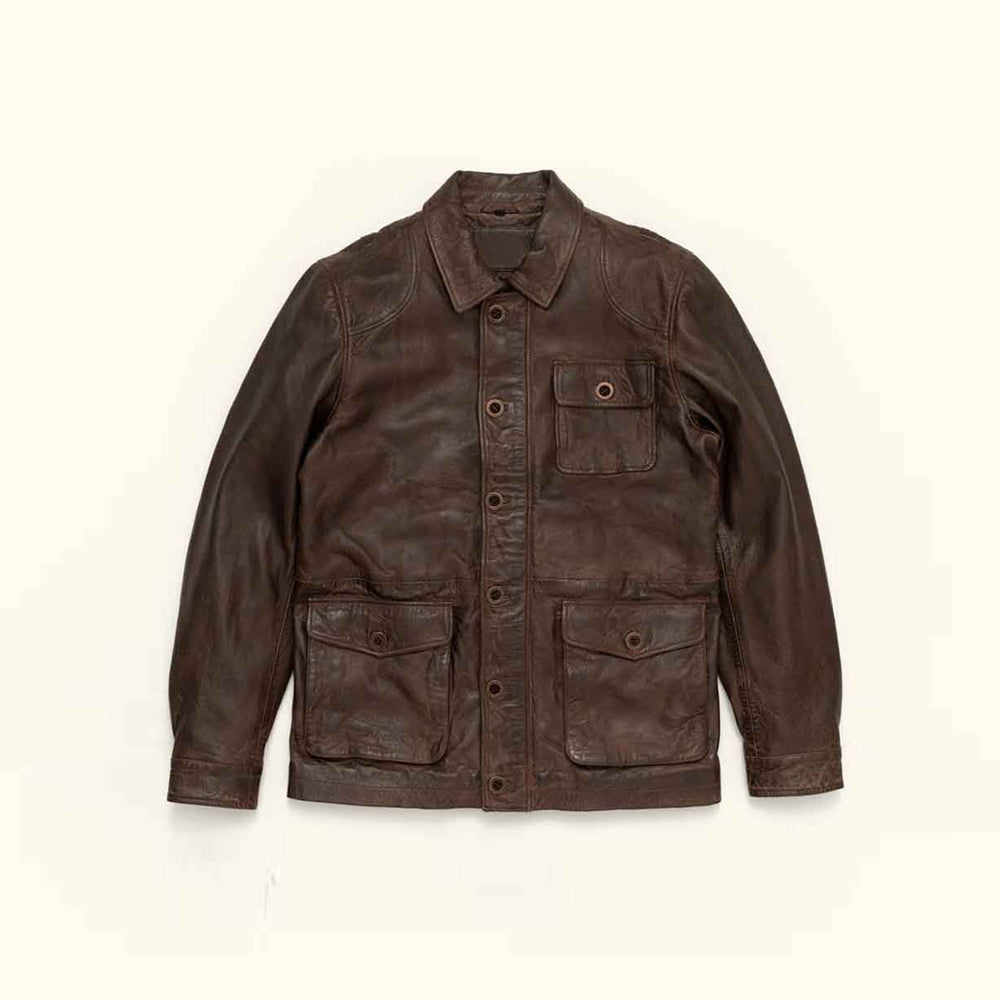 Flat front view of men’s vintage goatskin barn jacket with dark brown finish, point collar and three buttoned flap pockets