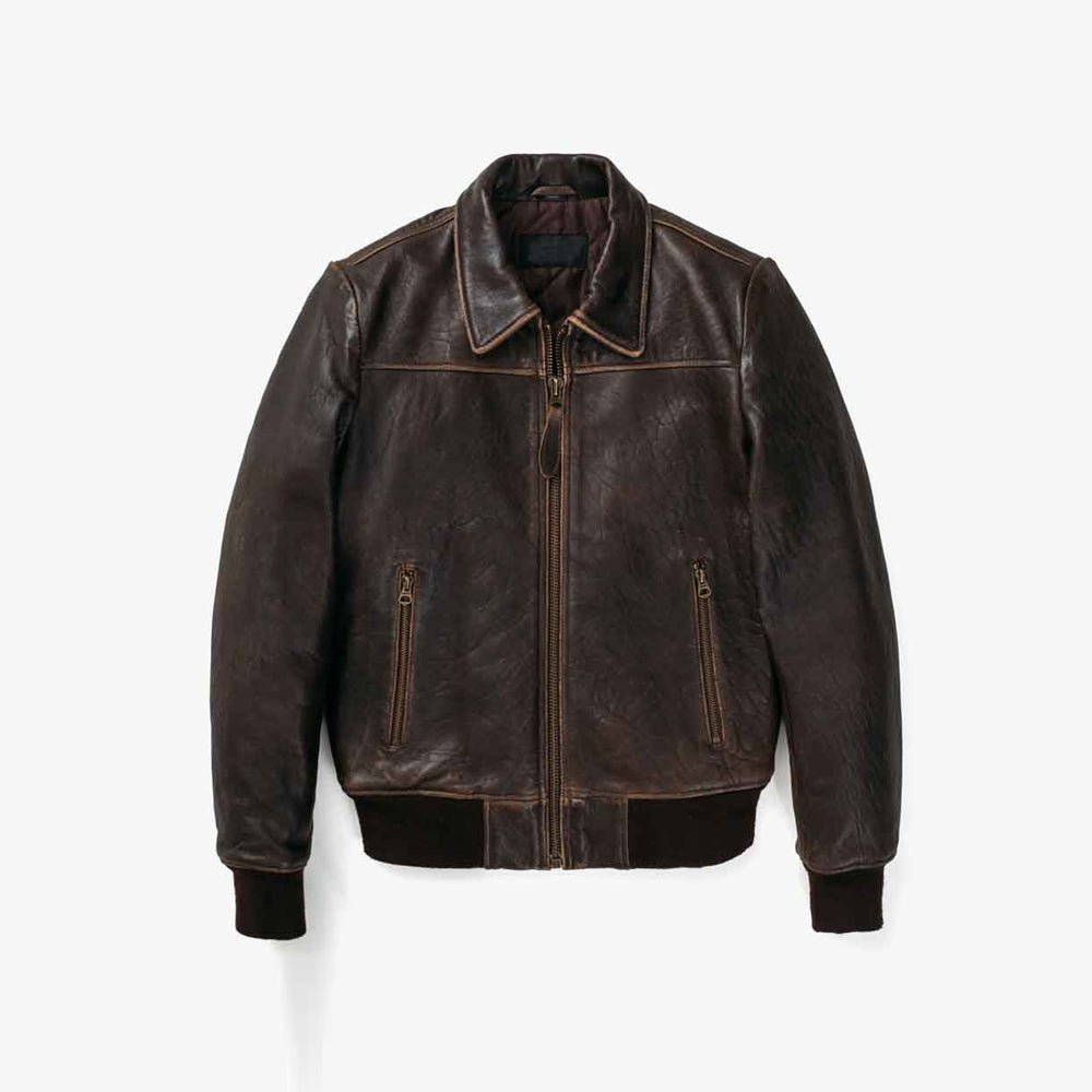 Front flat view of men’s vintage sheepskin flight jacket with distressed brown leather, point collar and two zip pockets