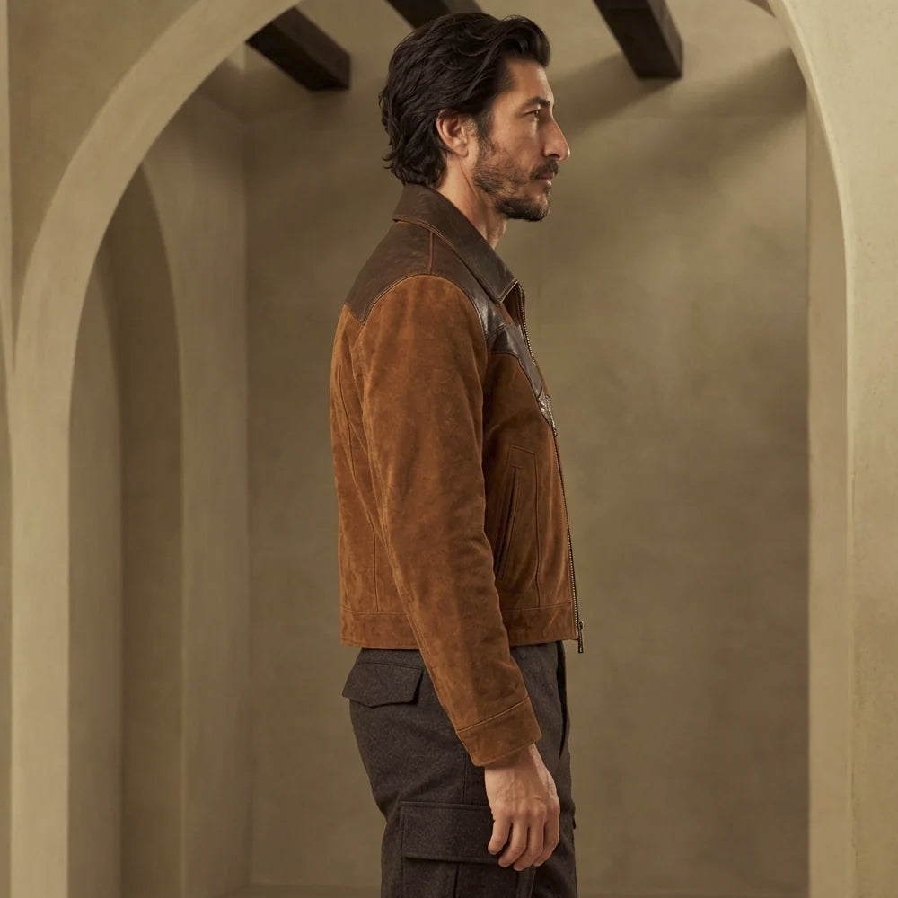 Side profile of men’s waist-length suede and leather jacket showing straight hem, clean cuff and shaped shoulder construction.