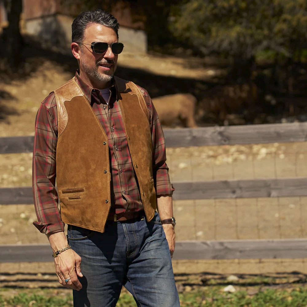 Front lifestyle view of a man wearing the tan Western suede ranchwear vest with an earth-tone plaid shirt