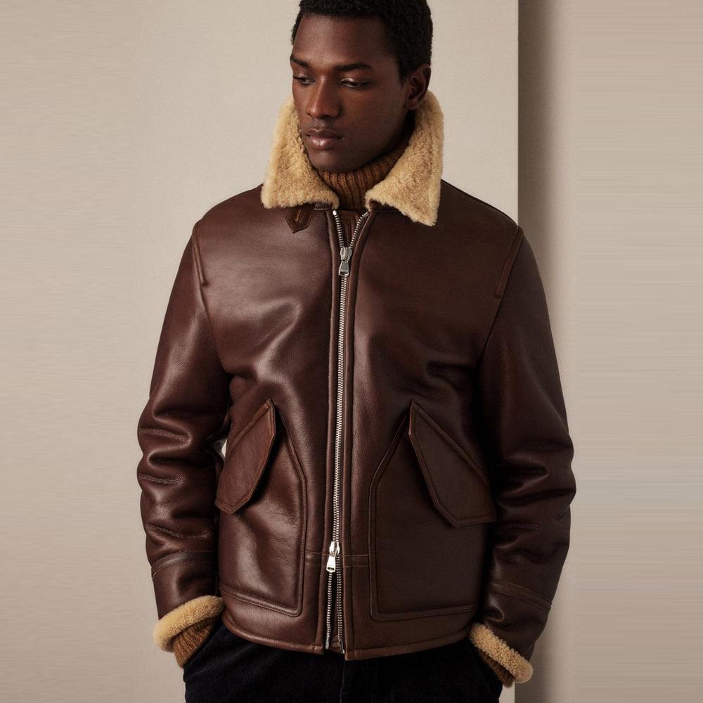 Male model wearing men's espresso shearling aviator jacket featuring spread fleece collar and dual-access pockets