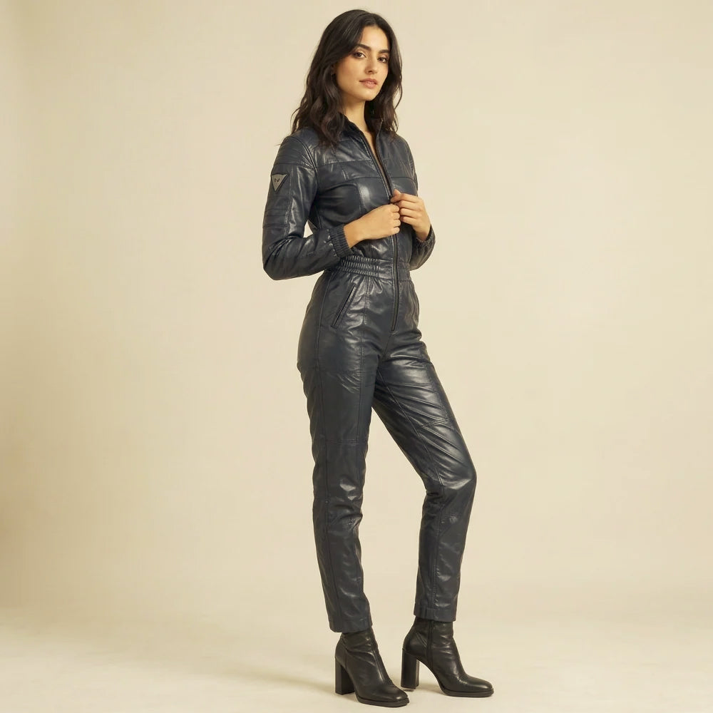 Side-angle view of a navy leather one-piece with a slim leg line, gathered cuffs and slanted hand pockets.