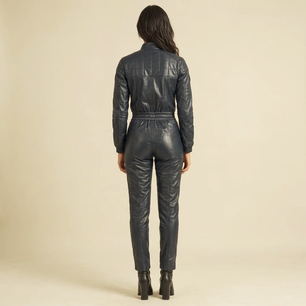Rear view of a women's navy leather moto jumpsuit with a grid-quilted shoulder yoke, gathered waistband and tapered legs.