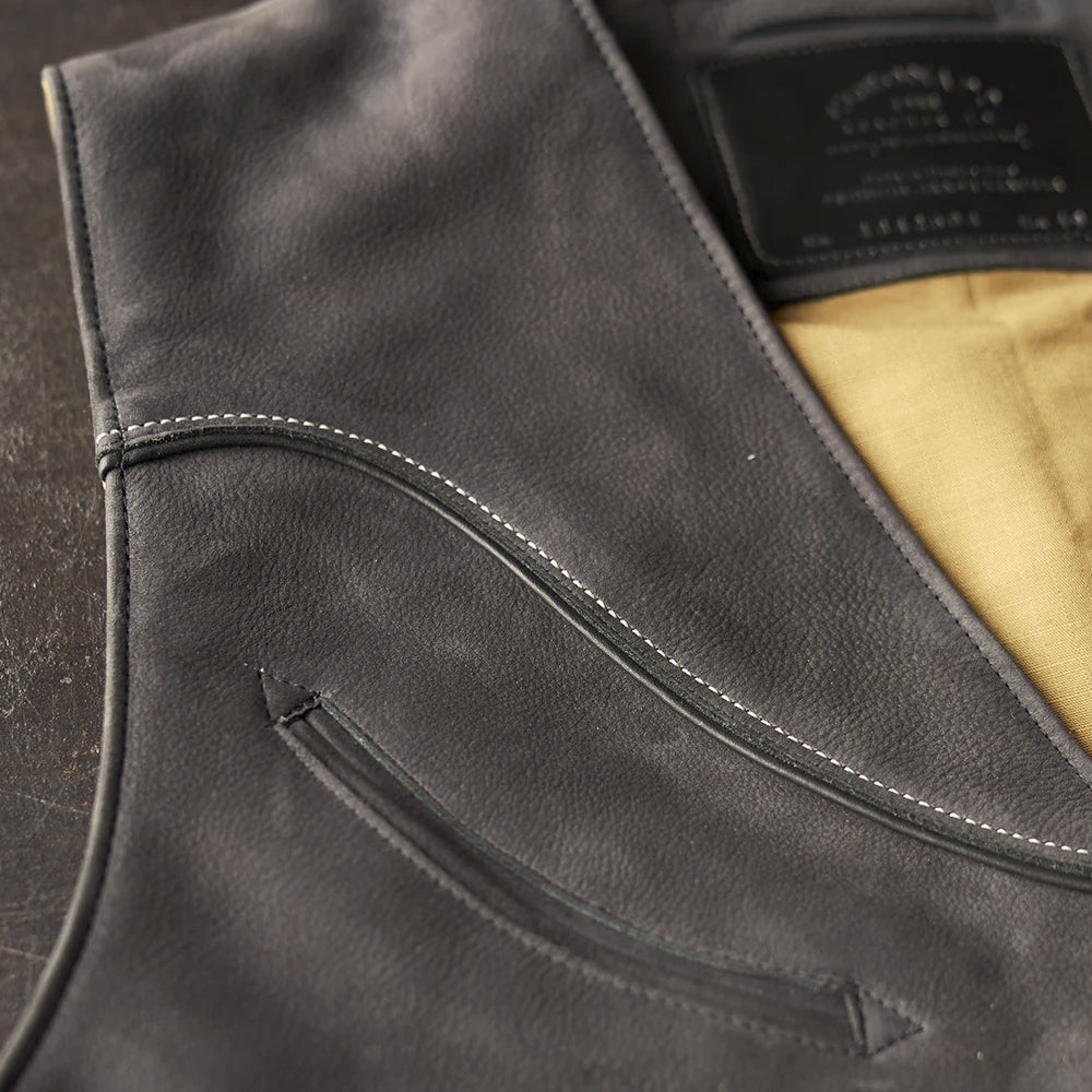 Macro view of the nubuck Western yoke showing double-row stitching, smooth piping and a curved chest welt