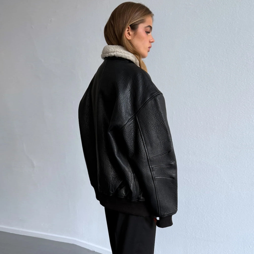 Rear three-quarter view of oversized black leather bomber jacket for women