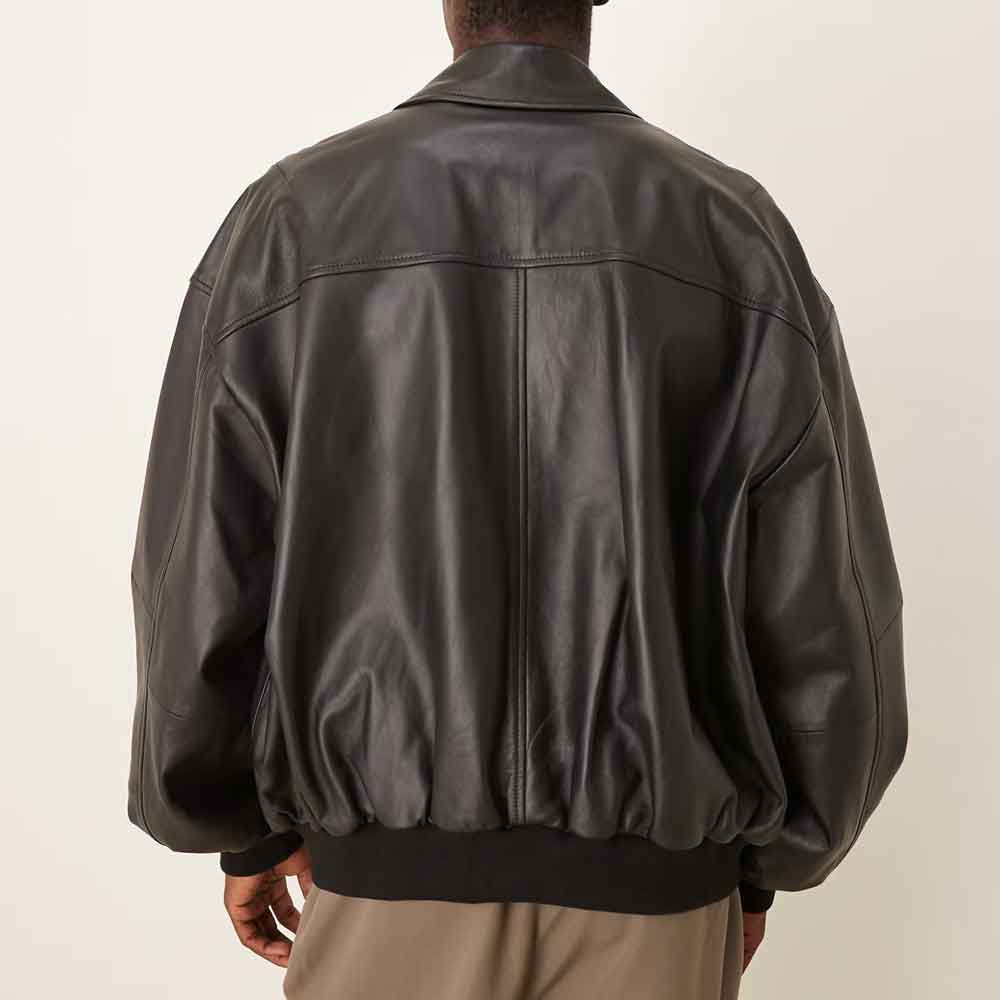Rear model view of oversized goatskin bomber showing dropped shoulders, broad yoke, center seam and ribbed waistband