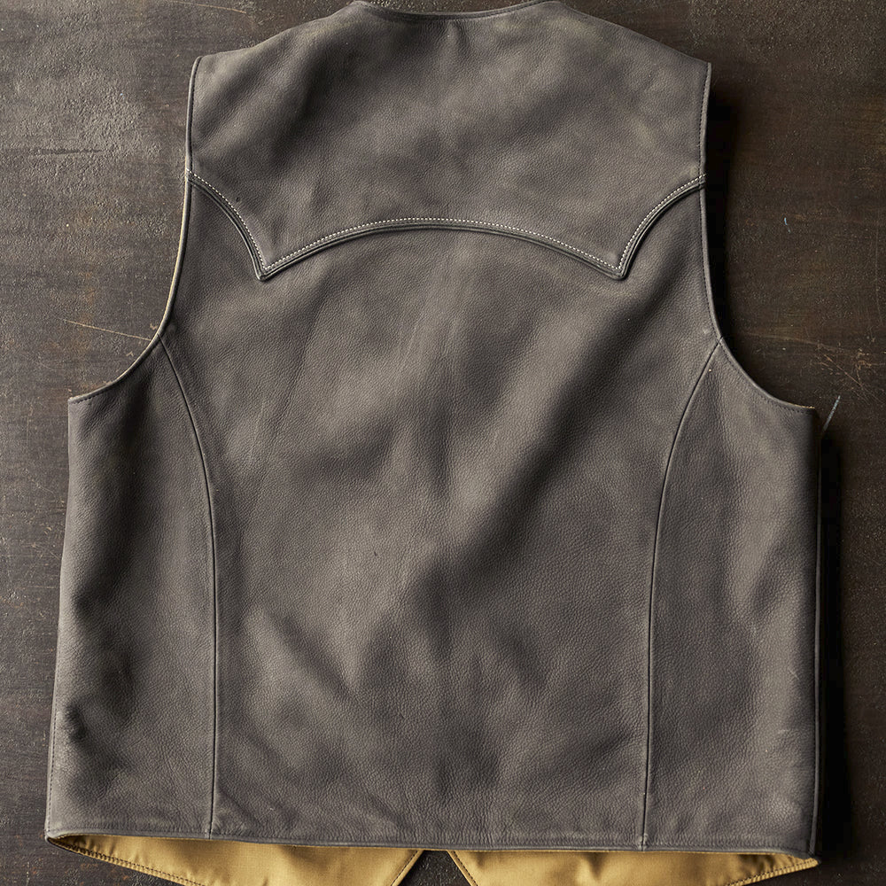 Rear view of the charcoal cowboy vest displaying an arched piped yoke, center seam and clean customization panel