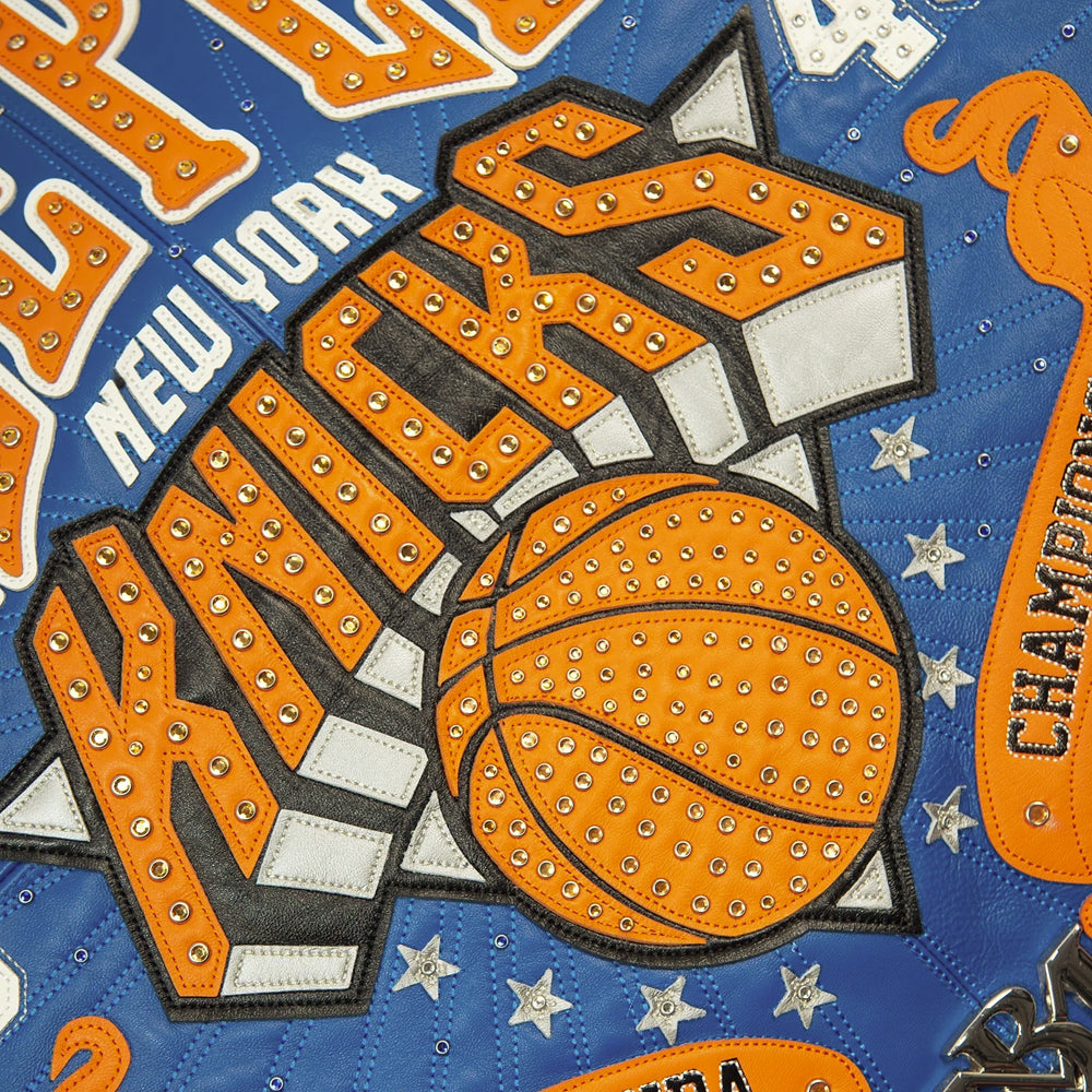 Studded orange Knicks basketball appliqué with stars and radiating blue stitchwork