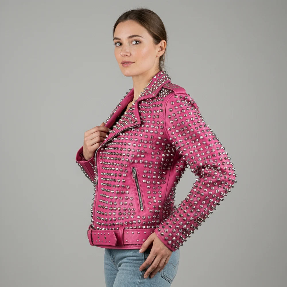 Side profile of women's pink studded leather jacket with belted waist and zip cuffs