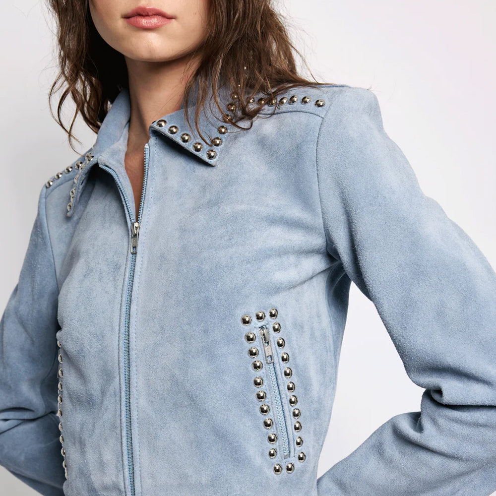Close-up focusing on the premium matte texture of the blue cowhide suede and metallic hardware rivets.