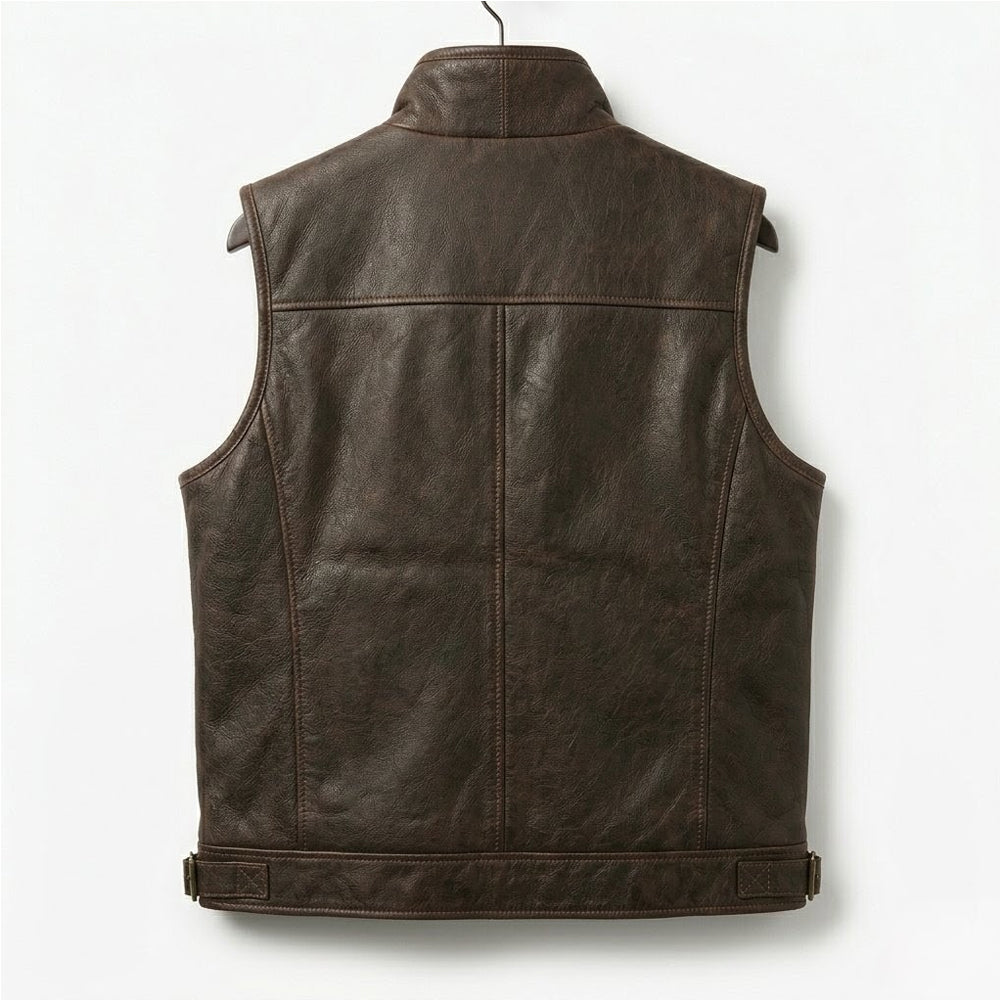 Close-up product shot of a premium brown sheepskin leather vest with shearling collar on a wooden hanger.