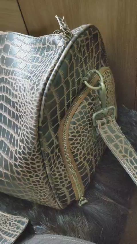 Product showcase video of the Premium Croc-Embossed Leather Duffle Bag, demonstrating the exotic texture, spacious interior, and durable brass hardware for travel.