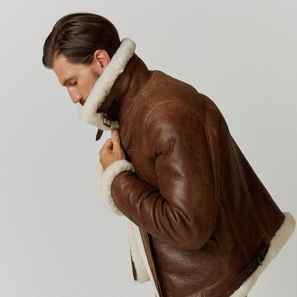 Side profile of model fastening buckled throat latch on plush white shearling collar of RAF flight jacket