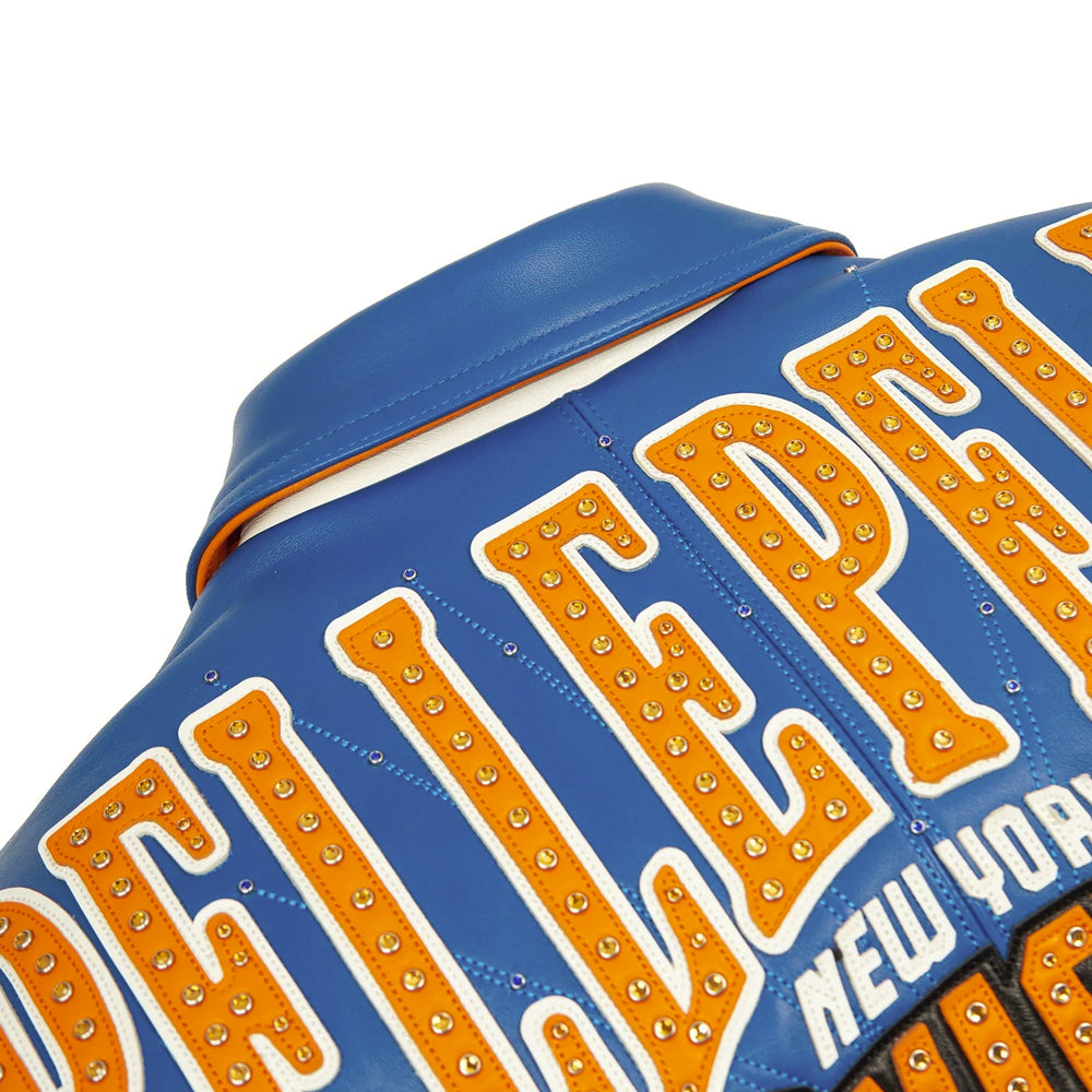 Close-up of royal blue leather point collar with orange piping and studded Pelle Pelle back lettering